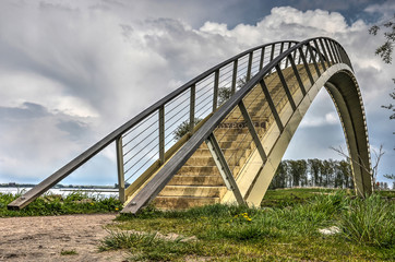 Fototapeta na wymiar The Ooypoort pedestrian bridge, at the time of construction the longest single-span composite bridge in the Netherlands gives pedestrians access to the Ooijpolder area