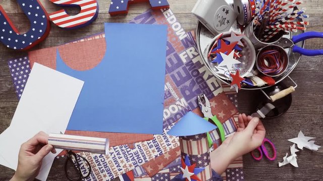 Step by step. Mother and daughter making paper firecrackers for July 4th celebration