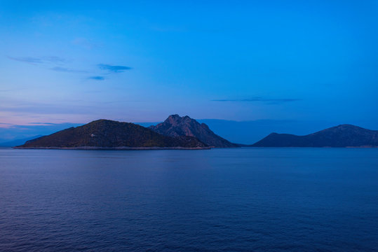 View of the Greek island of Atokos from the ferry at sunset. Greek islands in the Ionian Sea