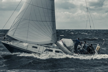 Blue sailboat at storm