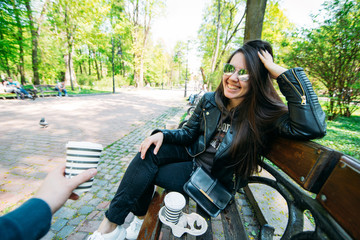 Fototapeta na wymiar couple sitting on bench drinking coffee. lifestyle concept