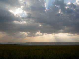 Rays of sunlight through cloud over plains of Africa
