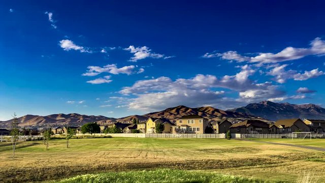 Panning time lapse of an urban area nin a valley wth the mountains in the background and a dramatic cloudscape overhead