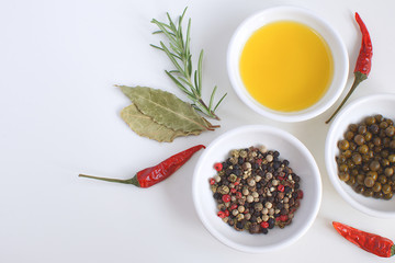 Olive oil porcelain plate Rosemary branch Pepper mix Chili Bay leaf Cooking concept White background Top view Copy space Flat lay