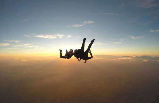 Skydivers having fun at the amazing sunset