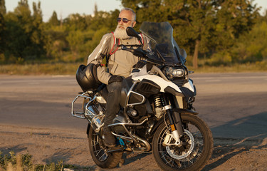 Fototapeta na wymiar Portrait of a senior man outdoors. Old biker portrait.