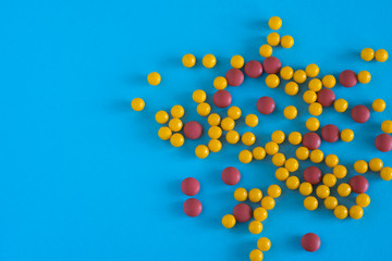 Assorted pharmaceutical medicine pills, tablets and capsules on blue background. Copy space for text. Medicine. top view