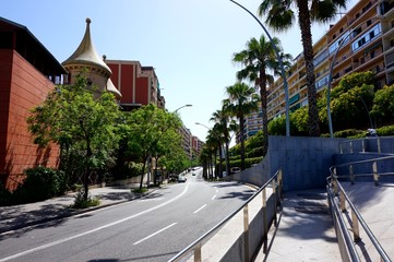 A typical city street of Barcelona, with cars riding along it.