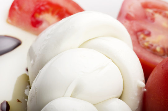 Mozzarella tomatoes and fresh salad on the white