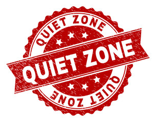 QUIET ZONE seal watermark with corroded texture. Rubber seal imitation has round medallion form and contains ribbon. Red vector rubber print of QUIET ZONE caption with corroded texture.