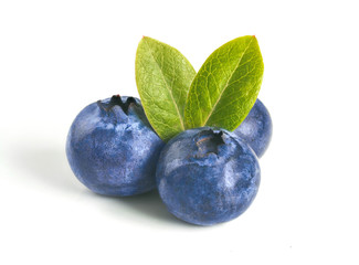 Blueberries isolated on white background. Extreme close up view of three blueberry berries with two green leaves. Isolated on white with clipping path.