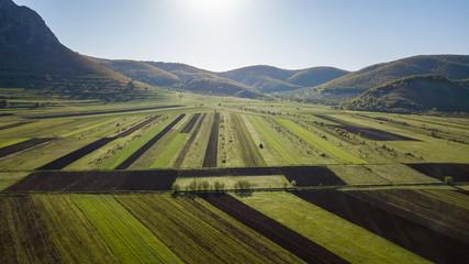 Aerial view of agricultural land during spring time in Romanian countryside.
