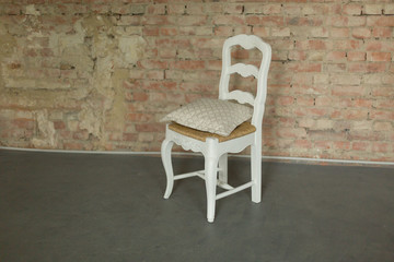 white chair on brick wall background. interior with brick wall. white chair with yellow seat. red brick wall