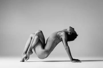  Young beautiful yoga woman is posing in studio. Black and white © Alexander Y
