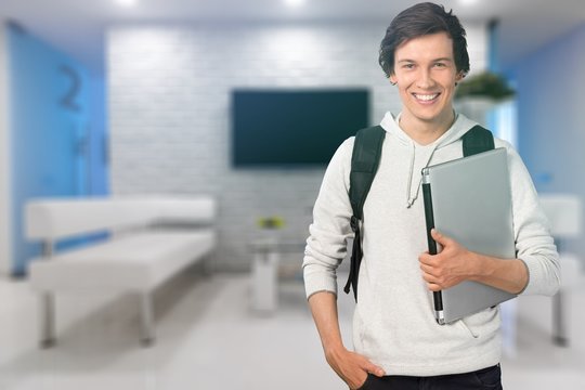 Smiling student man with laptop