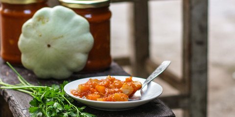 bush pumpkin in tomato sauce (a portion of salad) - conservation of products. food background
