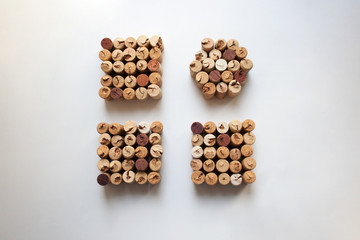 Wine corks square and circle shapes isolated on white background from a high angle view