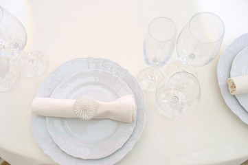 The banquet hall with round tables, with cutlery