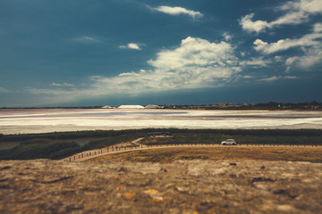 Aigues-Mortes, France, 23 June 2018: view from above to Aigues-Mortes sea salt basins, road and a white car