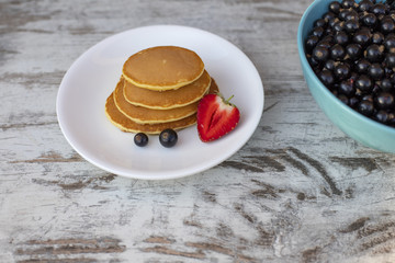 Pancakes with fruit. Breakfast with punkcakes. Pancakes in a pile on a plate.