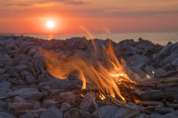 fire burns near the sea
