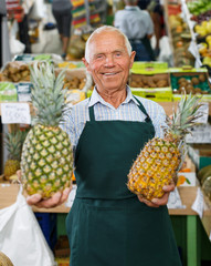 Owner of greengrocery offering fruits and vegetables