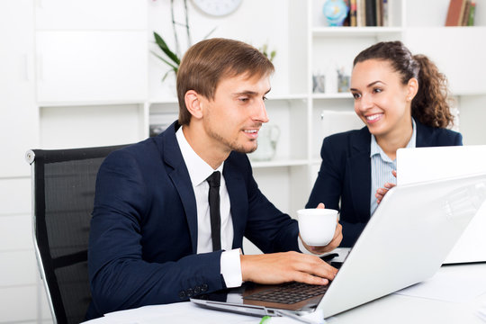 Man and woman coworkers working on computers