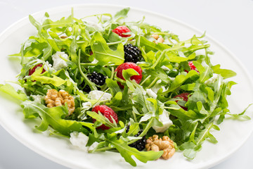 Salad with berry, nuts, goat cheese, olive oil.