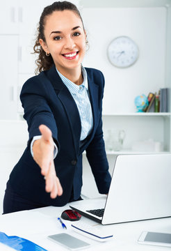 Businesswoman offers hand for greeting in  office