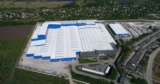 Construction of a large factory, Industrial exterior, panoramic view from the air. Construction site, metal structure. construction machinery, Aerial view of the construction