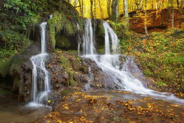 Fototapeta na wymiar Dokuzak waterfall in Strandja mountain, Bulgaria during autumn. Beautiful view of a river with an waterfall in the forest. Magnificent autumn landscape.