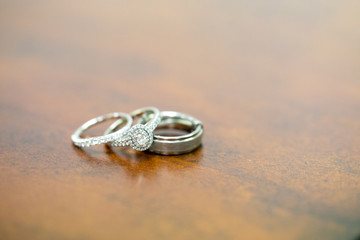White Gold and Diamond Wedding Rings on a Wooden Table