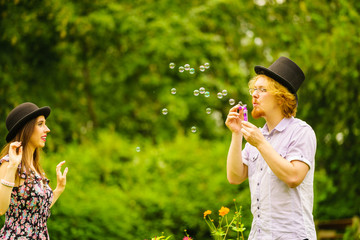 Couple blowing bubbles outdoor