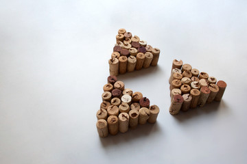 Wine corks triangles on white background with copy space