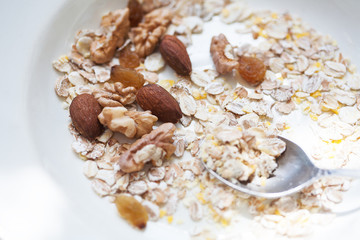 Oatmeal in bowl with nuts, useful food.