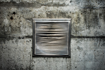 Grunge ventilation grid on old wall with cracks and grunge vintage ventilation outlet out of a mesh or grill.