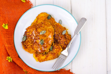 Pumpkin vegetable fritters on white wooden table
