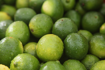 fresh green limes on the fruit market