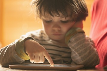 Boy using digital tab at home