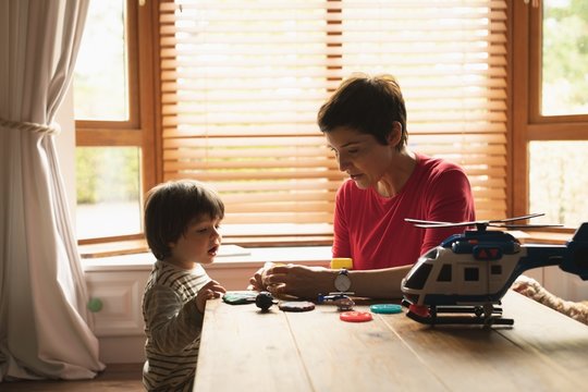 Mother playing with son on the table