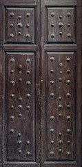 old rustic wooden door with metal rivet