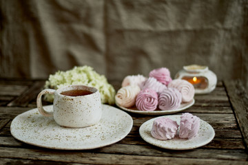 Delicate pastel colors. Tea party in the open air. Ceramics in a rustic style, handmade. Delicate marshmallow pink shades.