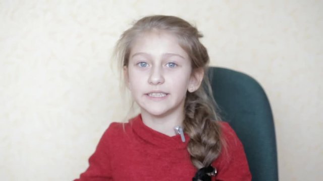 little girl in red clothes tells a story