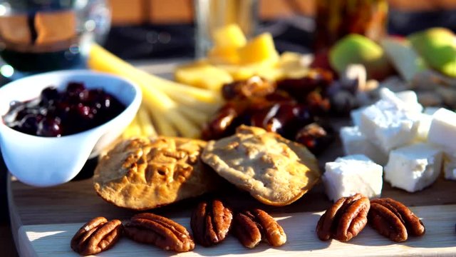 Cheese plate on wooden garden table 