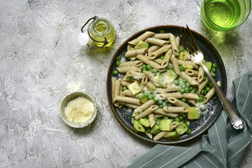Whole wheat pasta penne with zucchini and green pea.Top view.