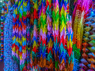 A thousand colorful origami cranes tied together on a string in Fukuoka