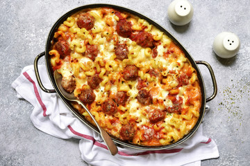 Pasta baked with meatballs and cheese in a skillet.Top view.