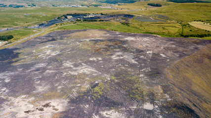 Aerial drone view of a large, buried landfill dump site in Wales