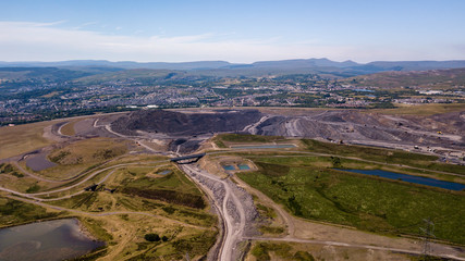 Aerial drone view of a large, buried landfill dump site in Wales
