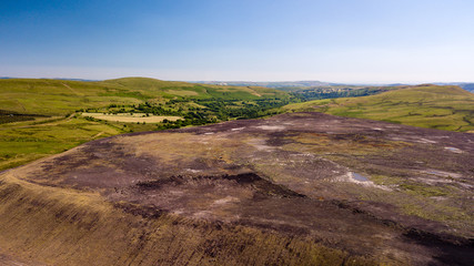 Aerial drone view of a large, buried landfill dump site in Wales